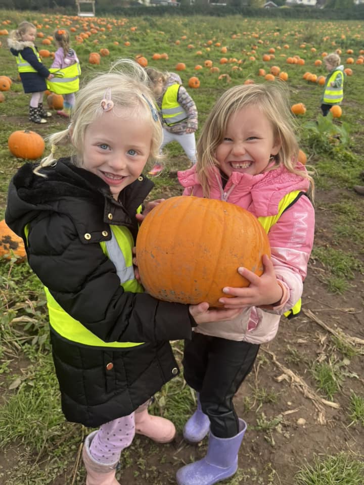 Children holding a pumpkin on a holiday club outing