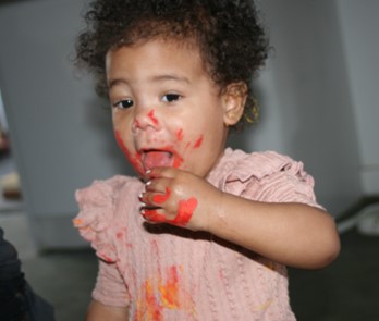 A child enjoying messy paint play