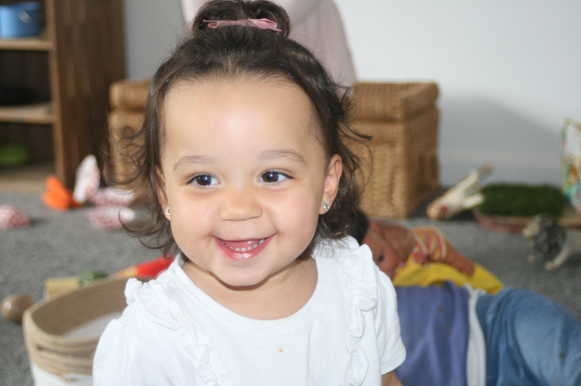 A smiling child at play in the nursery